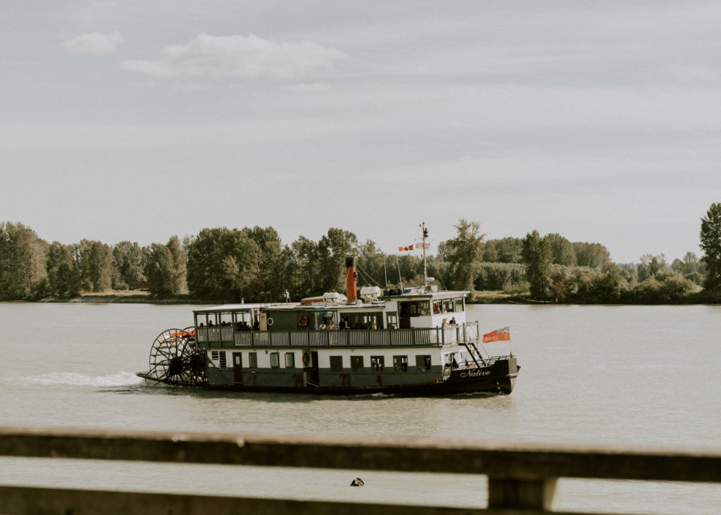 a Pitt Meadows wedding on the fraser river dock, with guests floating by